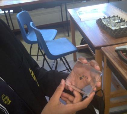student holds moon rock