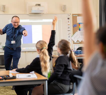 teacher talking to students in a provate primary school