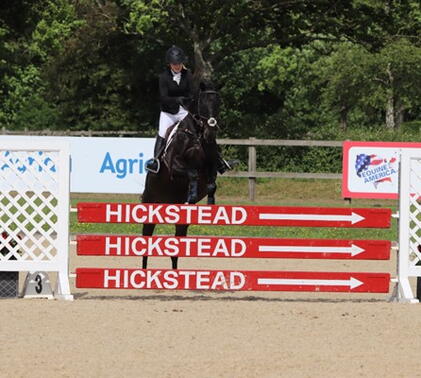 Sidcot rider performing a jump at competition
