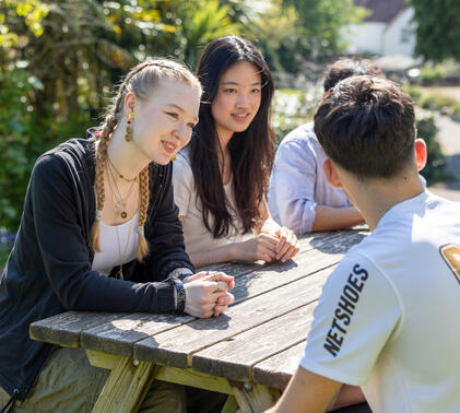 Sidcot international students sat at a picnic table
