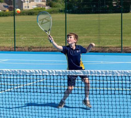 Sidcot Junior School pupil playing tennis