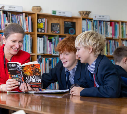 Kate Jones reading to two Year 7 students