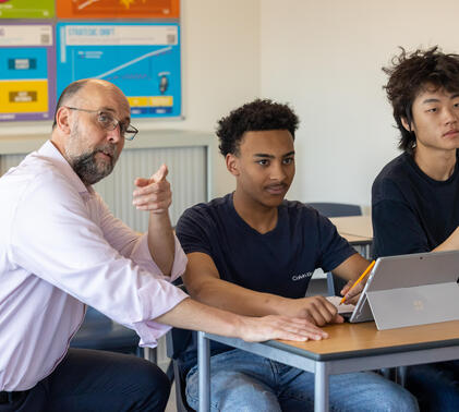 Teacher helping Sixth Form Boys