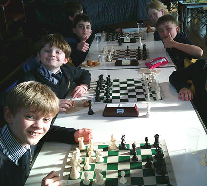 Junior school pupils playing chess
