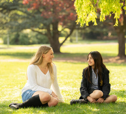 Two Sidcot students talking; one Sixth form, one in Year 7
