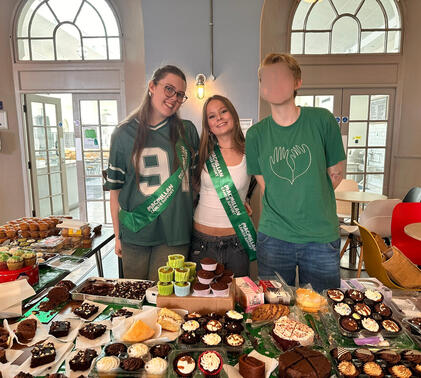Charity & Event Office Holders smiling at Macmillan Bake Sale