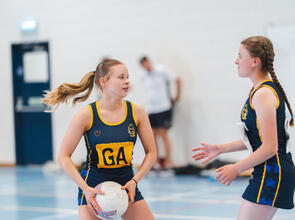Two girls playing netball