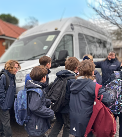 Kids lining up to get onto the minibus.