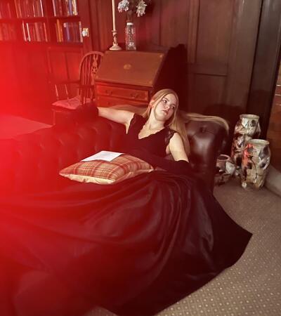 Girl lying on sofa in gothic costume