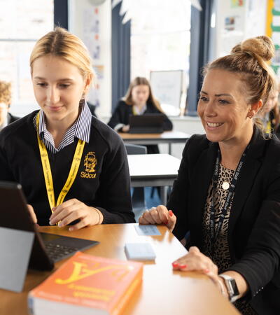 Teacher helping student in Spanish class