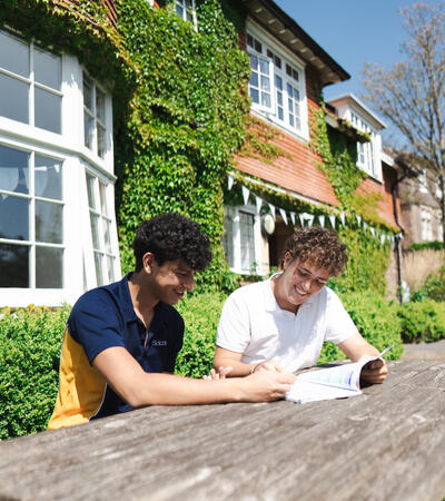 Two Sidcot students sitting outside a boarding house