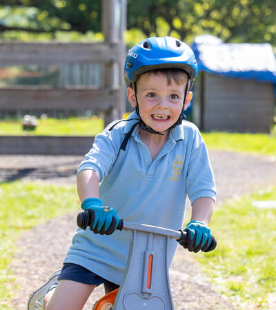 Sidcot Pre-School student riding a bike