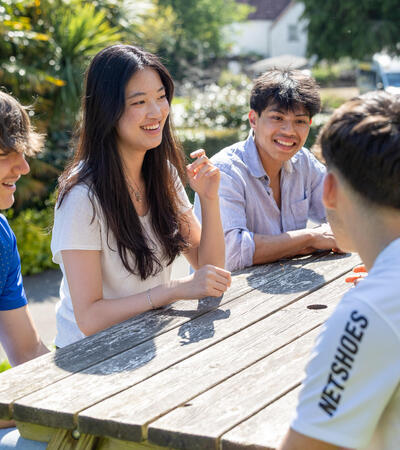 International students smiling and talking outside of Sidcot boarding houses