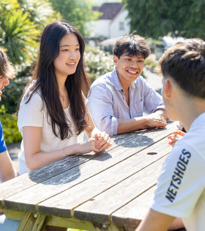 international students outside on bench