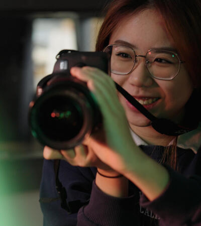 Sidcot Student holding camera