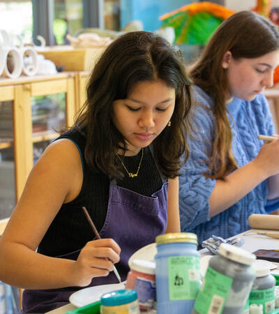 Sidcot students painting ceramics