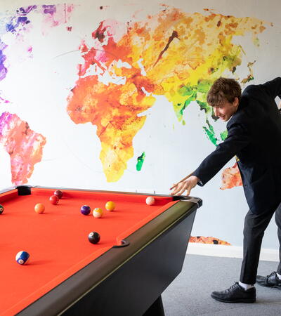 one sidcot student playing pool in Wing boarding house