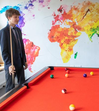 boys playing pool in boarding house