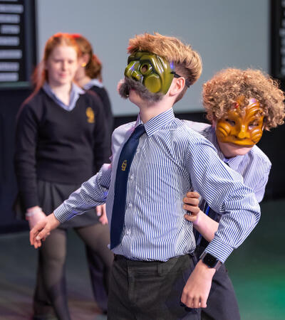 Sidcot students wearing masks acting a scene in a drama class
