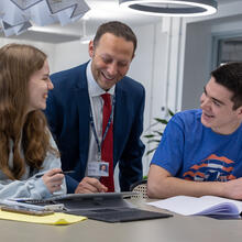 Two students with the Head of Sixth Form, Tom Ruddle in the Sixth Form Centre