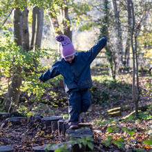 Sidcot Pre-School pupil playing in Forest School
