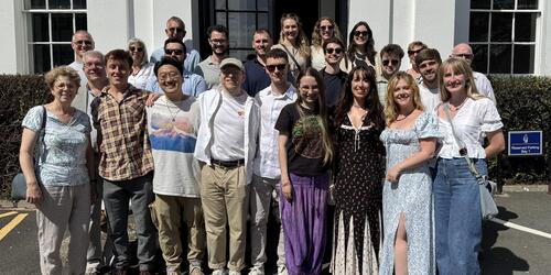 Group photo of alumni students outside the main Sidcot school building