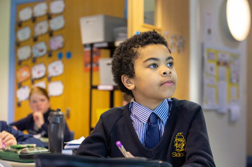 child listening at a provate primary school
